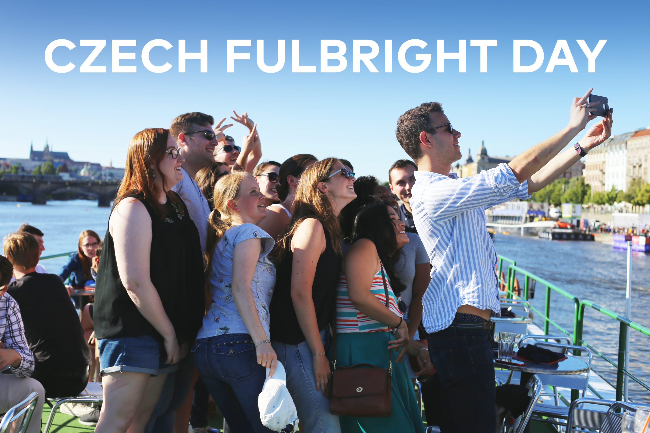 A photo of a group of young people outside taking a selfie with the text "Czech Fulbright Day" in white at the top