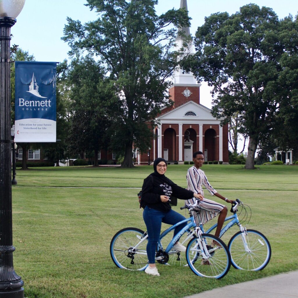 FLTAs perching on bikes at Bennet College