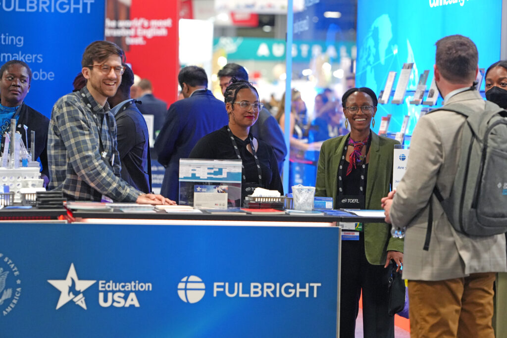 Fulbright Alum at NAFSA Booth talking to attendees