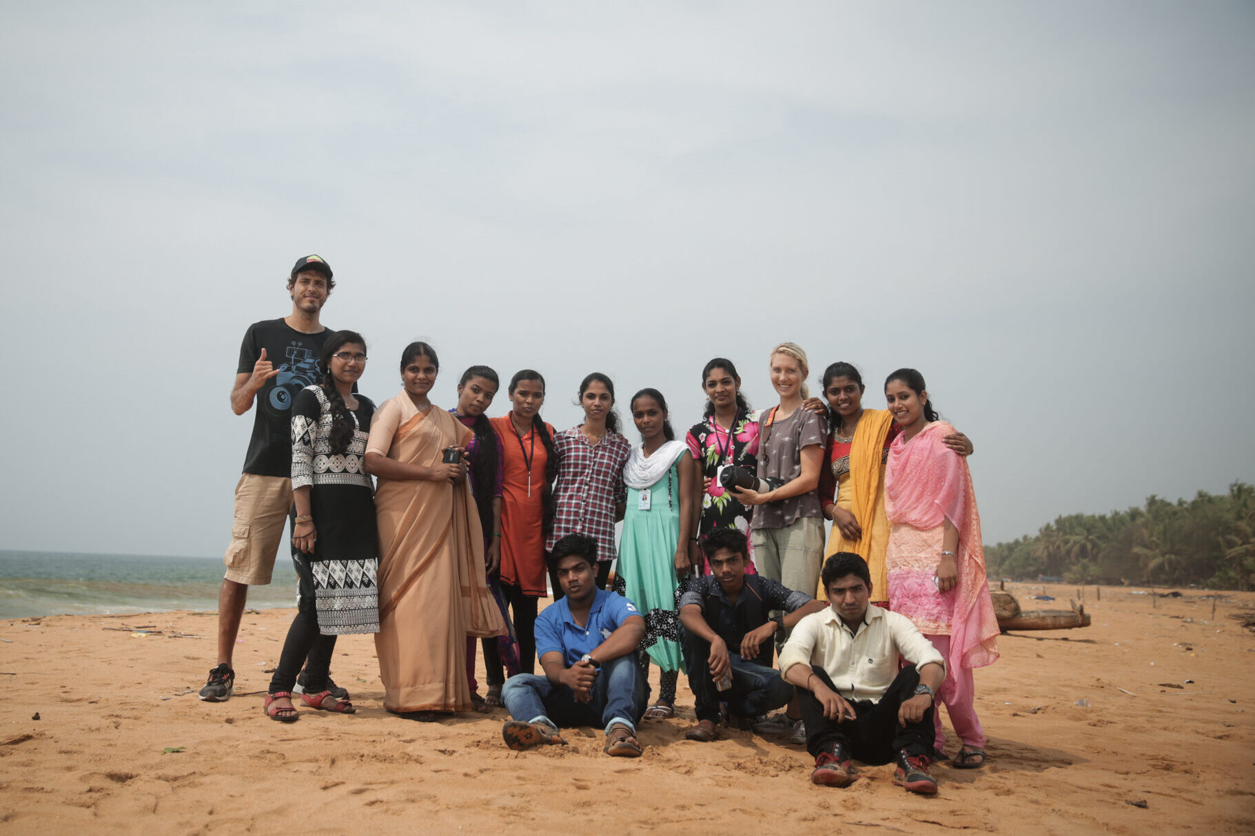 Group of people standing together on beach