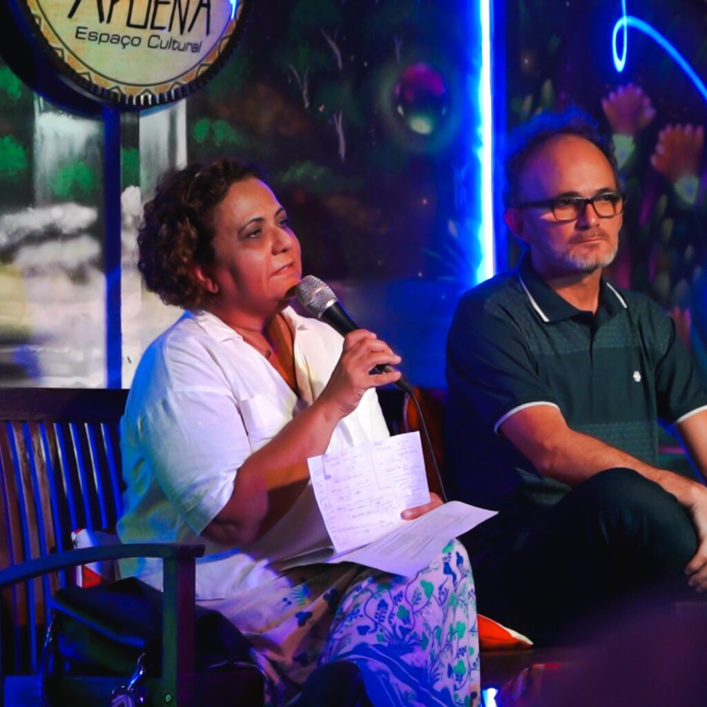 Woman sitting with microphone presenting