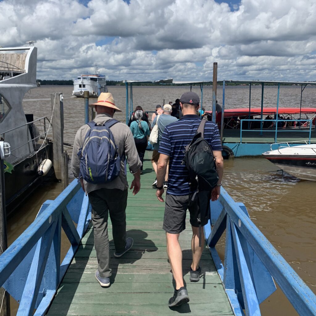 Group of Fulbright Amazonia scholars walking down river dock