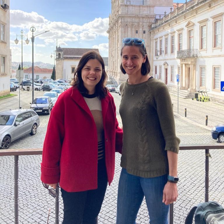 Two women standing in front historical building