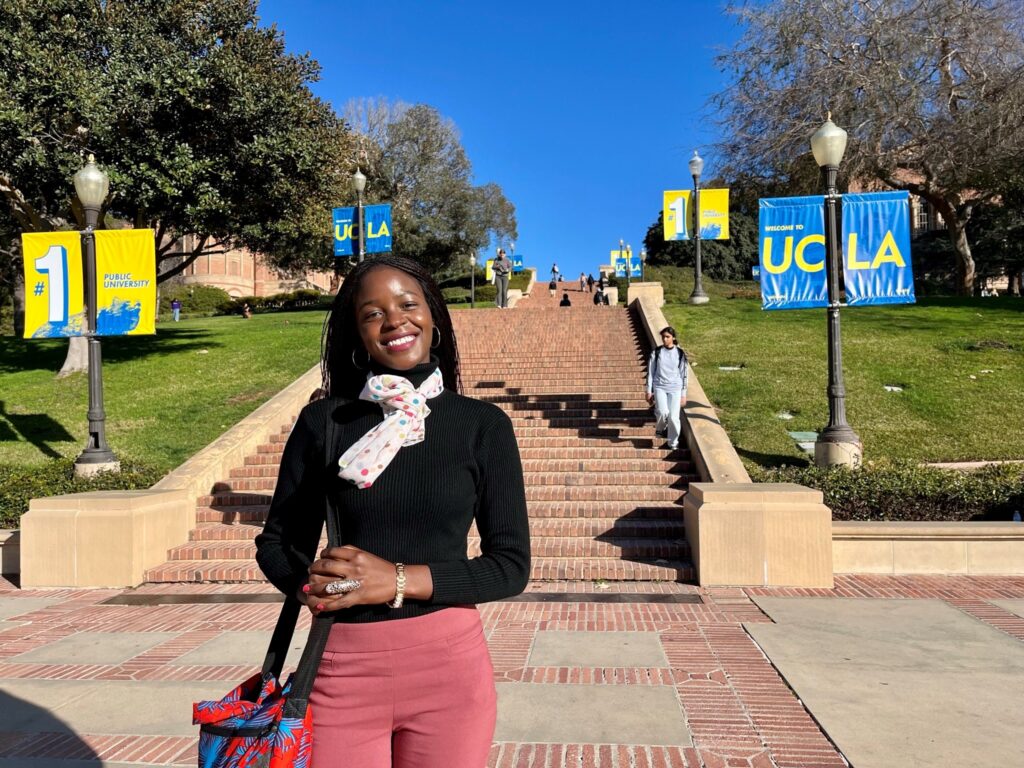 Student posing in front of stone stairs