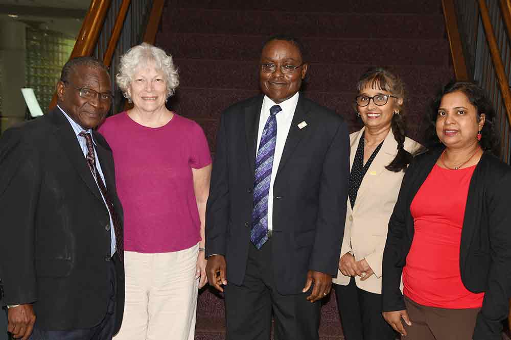 Group of Fulbright alumni standing in front of staircase.