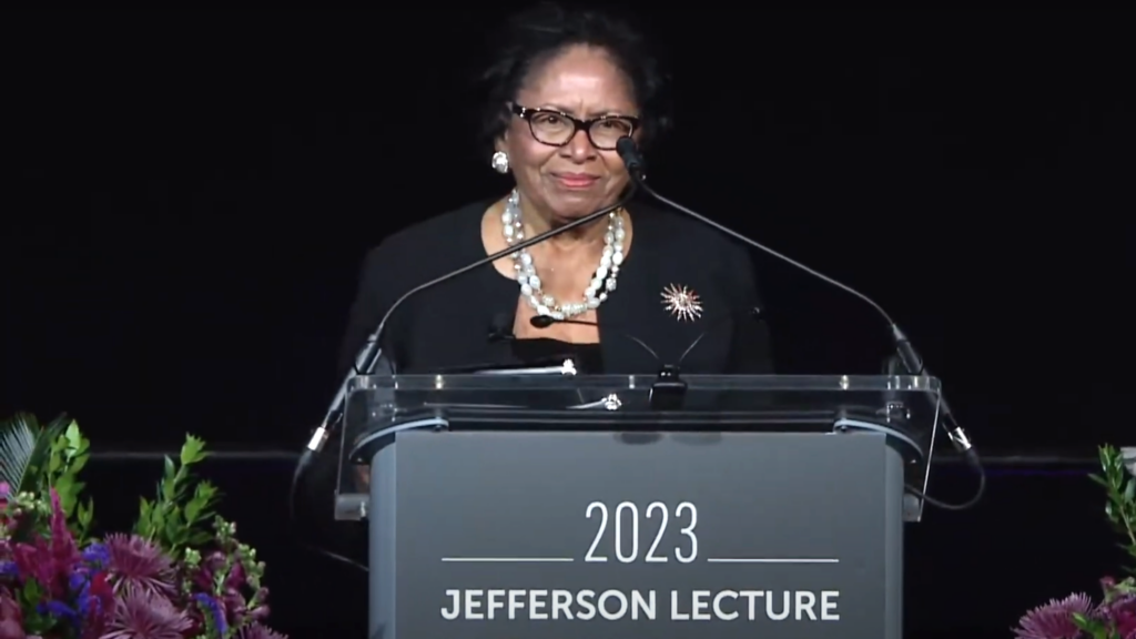 Ruth Simmons standing at podium giving lecture at the Smithsonian National Museum of African American History.