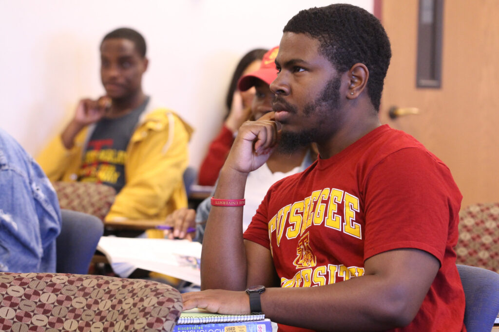 Student sitting classroom in Tuskgee University tshirt