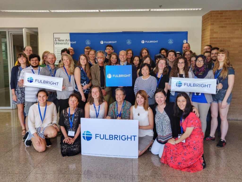 Group of Fulbrighters posing with Fulbright signs at Pre-Departure Orientation hosted by Arizona State University