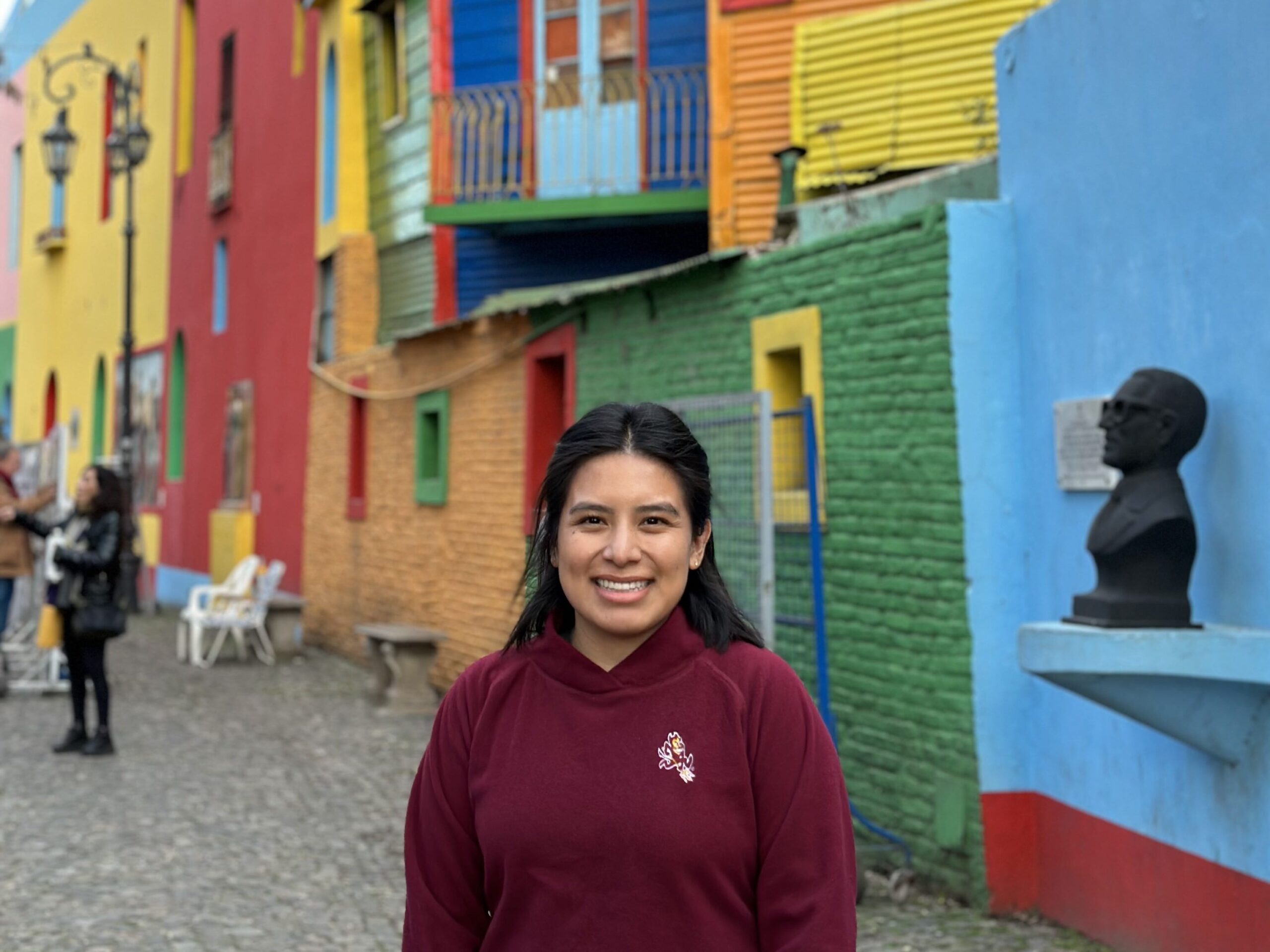 Fulbrighter standing in front of colorful houses in Argentina