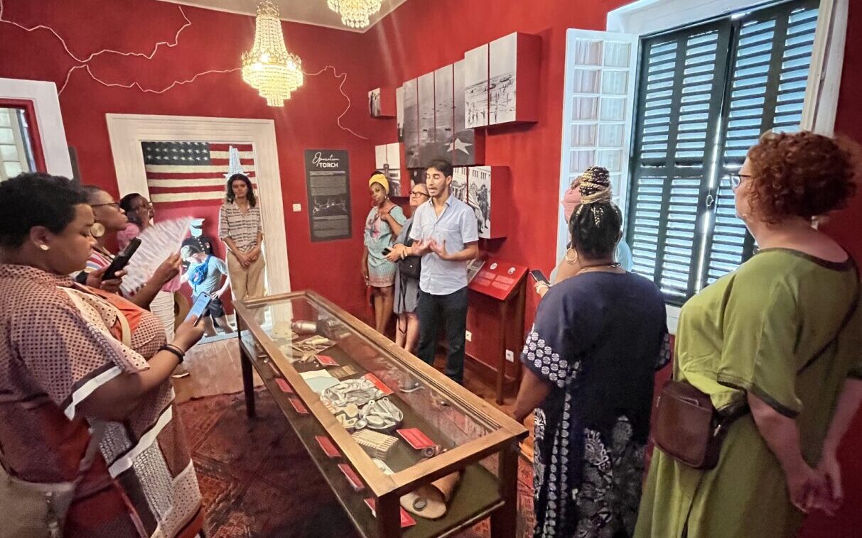 Group of people standing around exhibit in museum