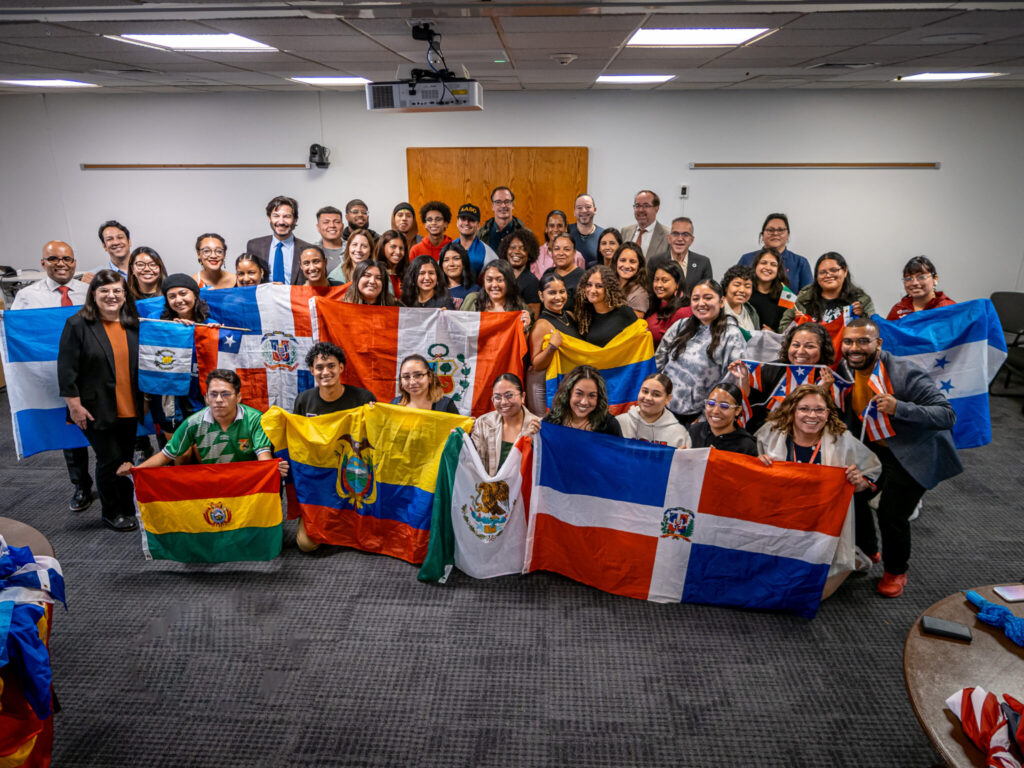 Large group of students holding colorful flags of different nations