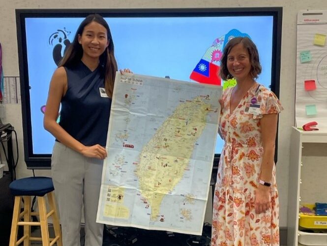 Fulbrighter and teacher holding map of Taiwan in classroom