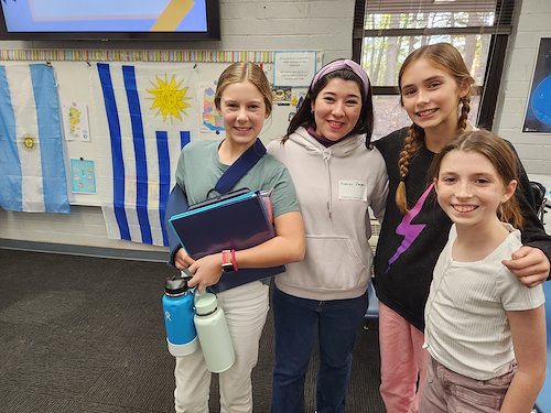 Students standing together in classroom