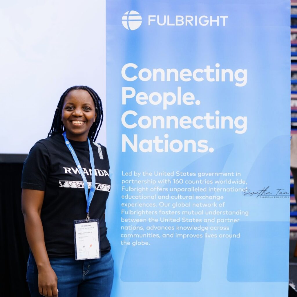 Jeanne standing by Fulbright sign