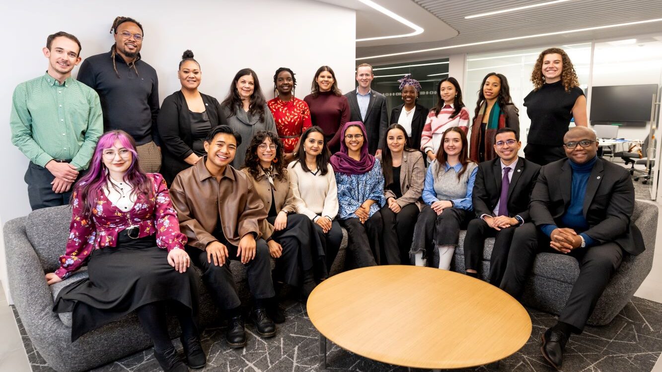 Fulbright Alumni Ambassadors posing for group shot around coffee table