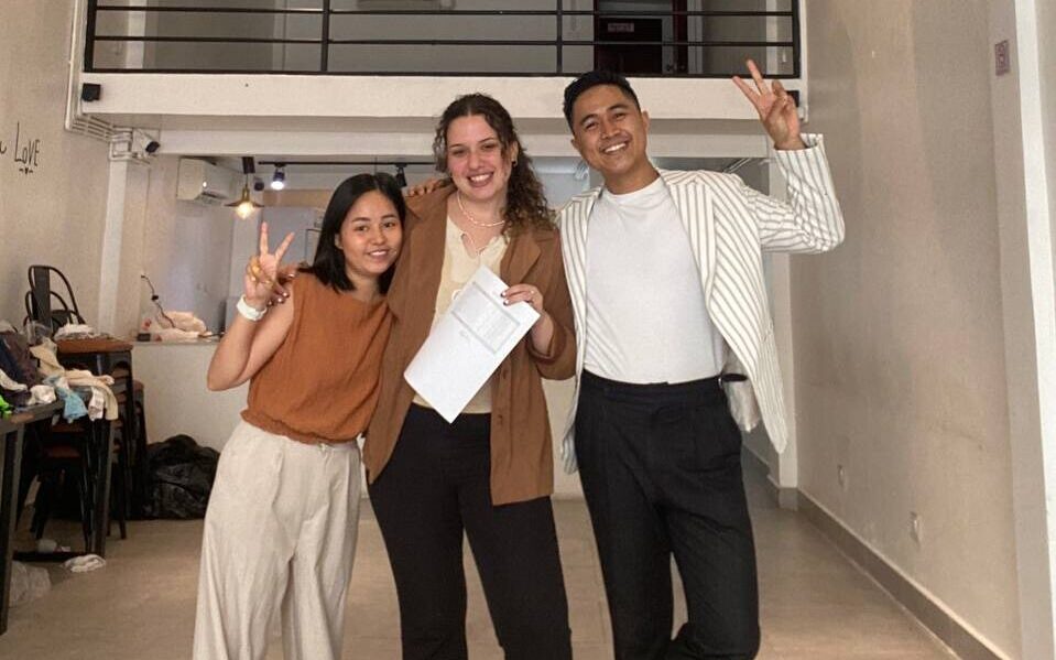 Alyssa Kardos Loera with two people posing with peace signs