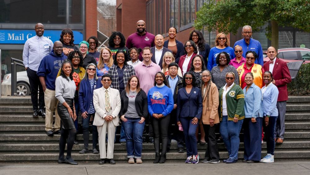 HBCU FPAs standing on stairs with buildings behind them