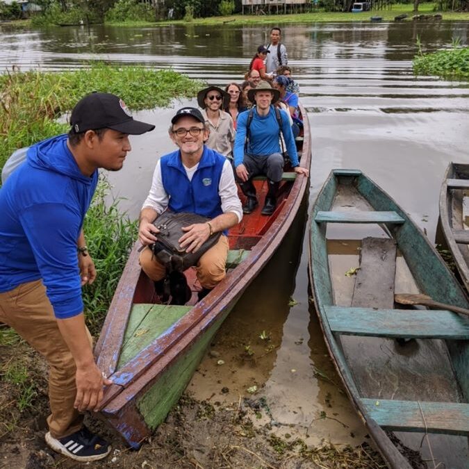 Amazonia scholars on long boat