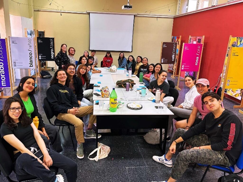 Group of students sitting around large table in studio