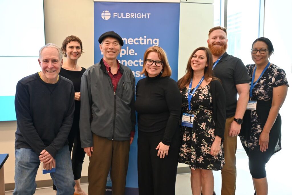 Scholar Liaisons standing in front of Fulbright sign.