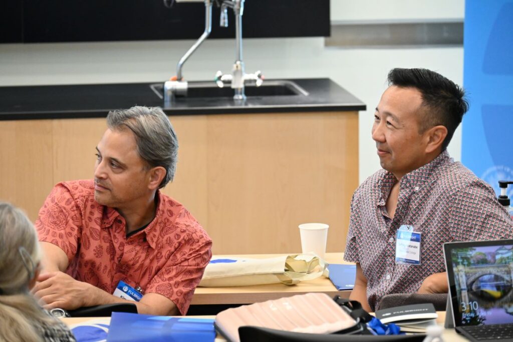 Scholar liaisons sitting at desks looking away from camera