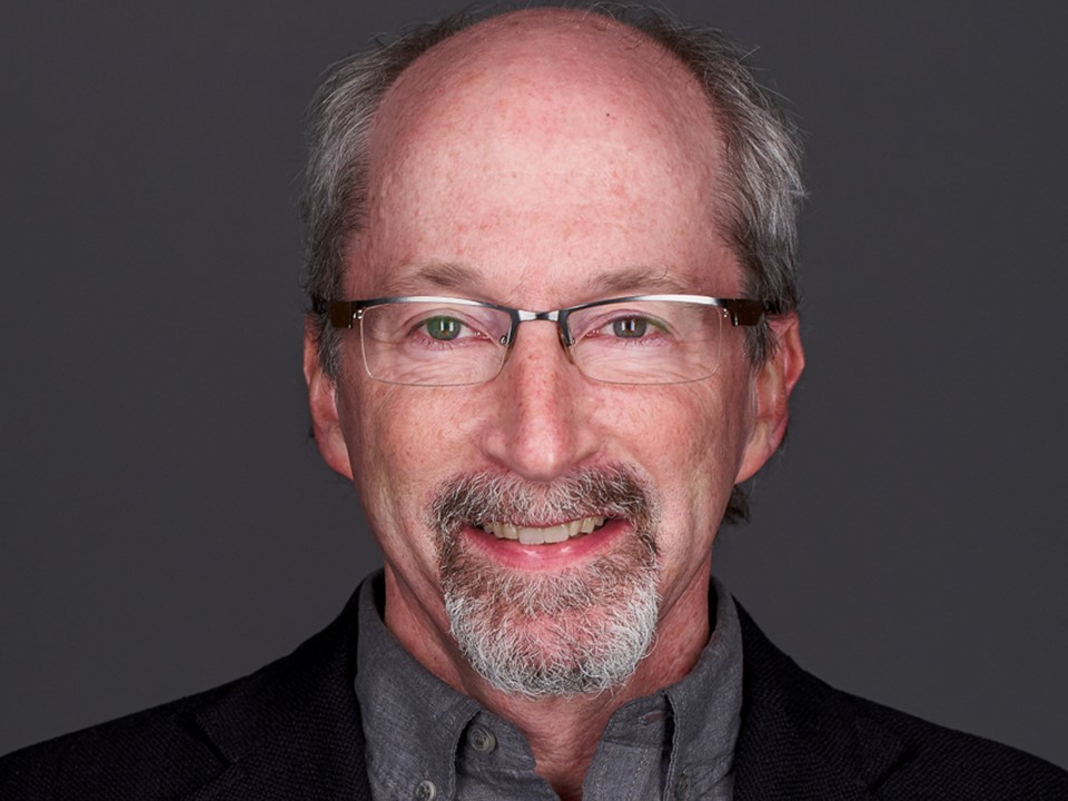 Headshot of Benjamin Nathans with glasses and a beard, wearing a dark blazer and shirt against a gray background.