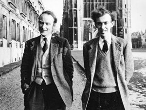 1950s black and white photo of two men walking on the street with buildings in the background, wearing tweed jacket and ties 